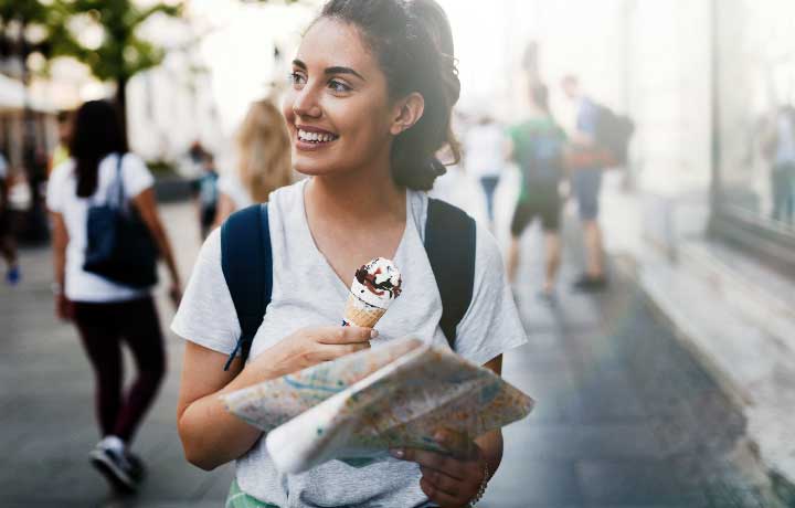 beautiful-woman-eating-ice-cream-outdoors-3GF5BML